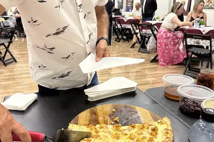 Anfitrião servindo a pizza recém-cortada