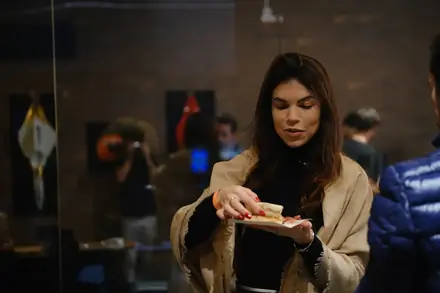 Convidada provando a pizza no evento corporativo