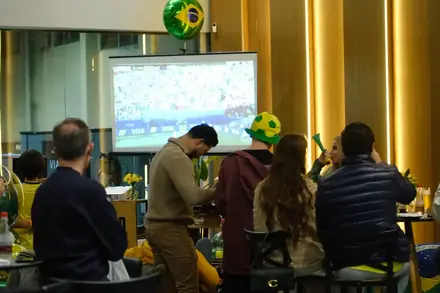 Convidados em volta da estação de pizza durante a festa