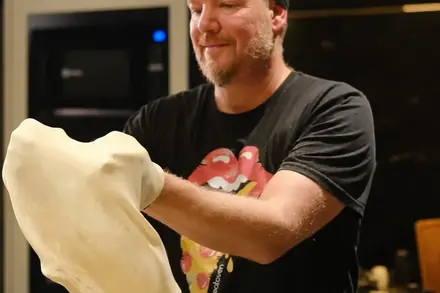Mão abrindo a massa de fermentação de 48 horas da BeatOven