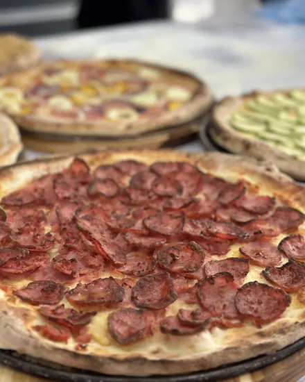 Pizza de pepperoni na tábua, pronta para ir à mesa