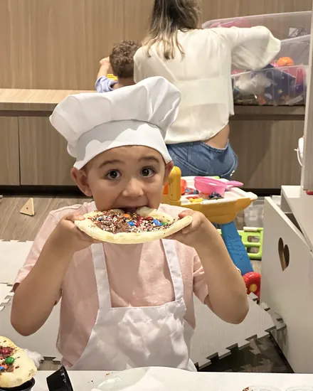 Criança mostrando a pizza doce que decorou